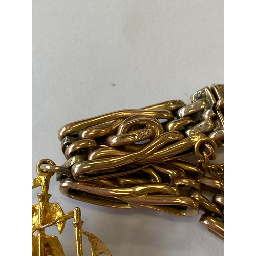 40 - A rose metal decorative link bracelet with attached charms, the rose metal bracelet with integral cl... 