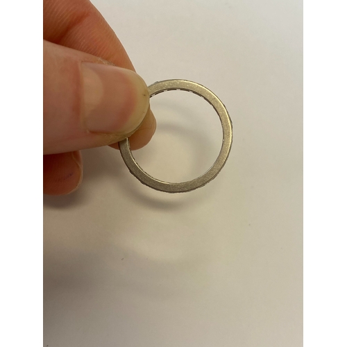 41 - A diamond set eternity ring, the round faceted diamonds claw set in white metal to white metal shank... 