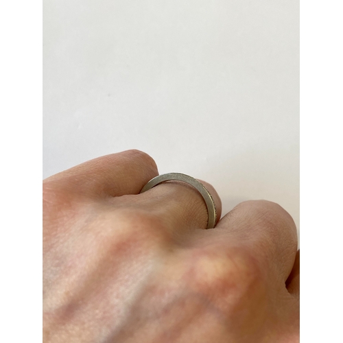 41 - A diamond set eternity ring, the round faceted diamonds claw set in white metal to white metal shank... 