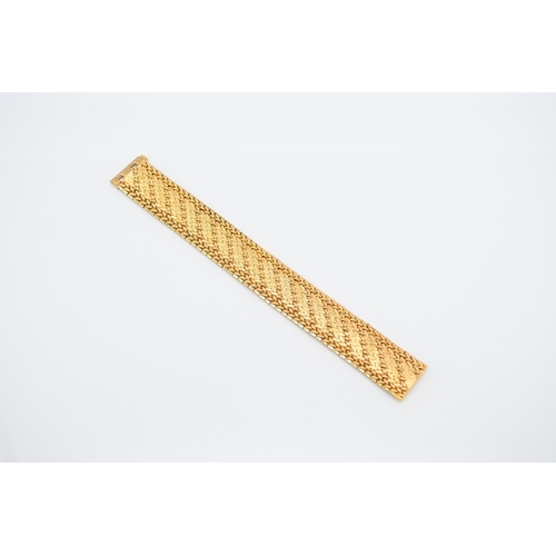 42 - A French yellow metal bracelet, the polished and textured integral links of stylised leaf design, wi... 