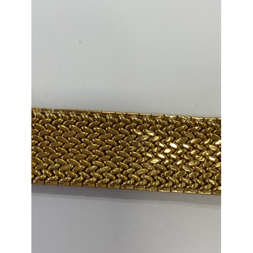 42 - A French yellow metal bracelet, the polished and textured integral links of stylised leaf design, wi... 