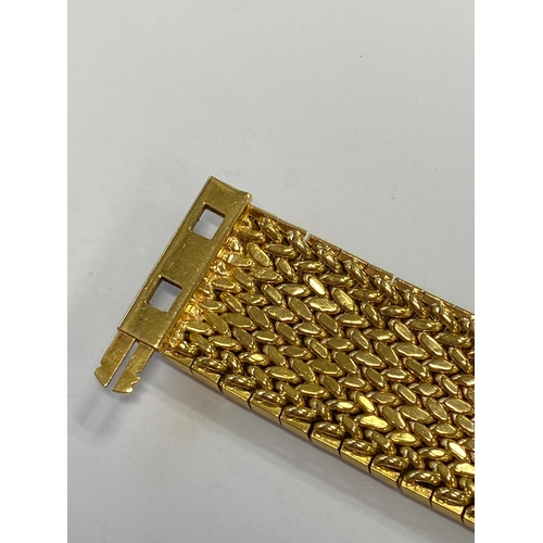 42 - A French yellow metal bracelet, the polished and textured integral links of stylised leaf design, wi... 