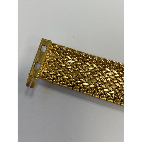 42 - A French yellow metal bracelet, the polished and textured integral links of stylised leaf design, wi... 