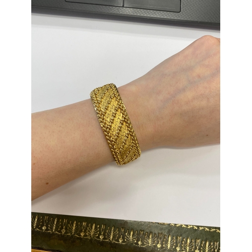 42 - A French yellow metal bracelet, the polished and textured integral links of stylised leaf design, wi... 