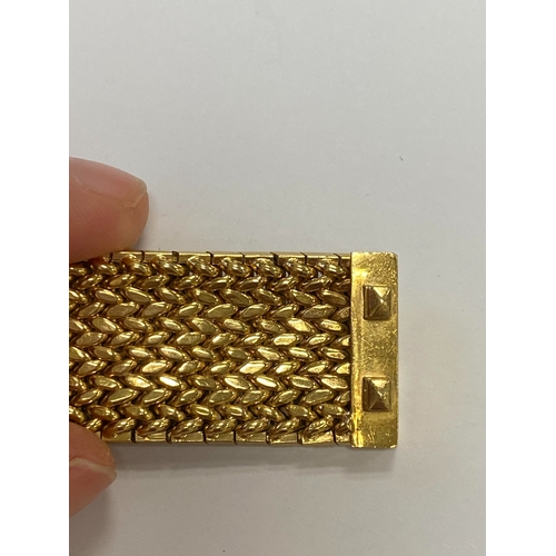 42 - A French yellow metal bracelet, the polished and textured integral links of stylised leaf design, wi... 