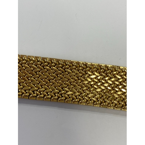 42 - A French yellow metal bracelet, the polished and textured integral links of stylised leaf design, wi... 
