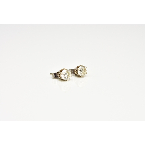 43 - A pair of diamond stud earrings, the brilliant cut diamonds claw set in white metal with post fittin... 