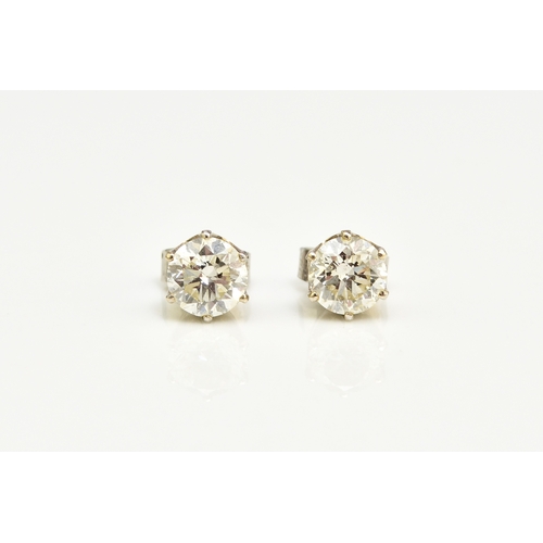 43 - A pair of diamond stud earrings, the brilliant cut diamonds claw set in white metal with post fittin... 
