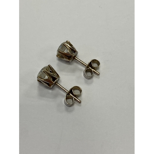 43 - A pair of diamond stud earrings, the brilliant cut diamonds claw set in white metal with post fittin... 