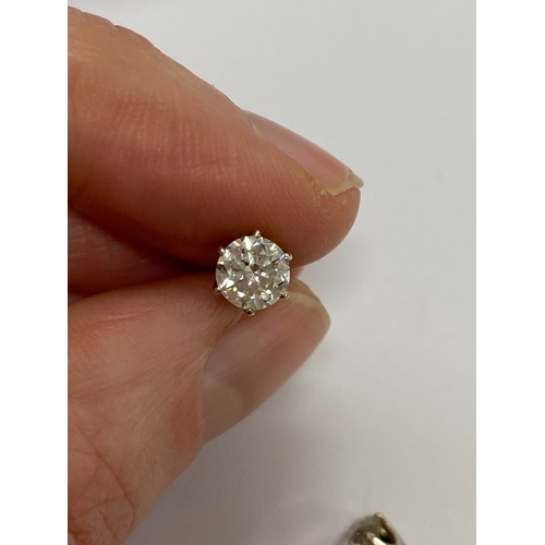 43 - A pair of diamond stud earrings, the brilliant cut diamonds claw set in white metal with post fittin... 