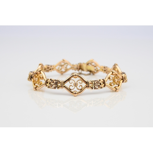 45 - A yellow metal decorative link bracelet, designed as seven openwork scroll links each interspersed w... 