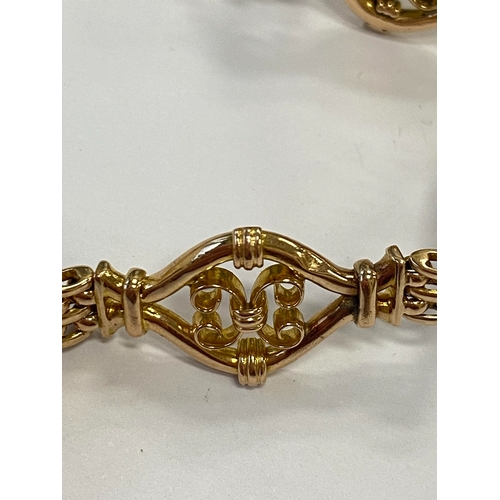 45 - A yellow metal decorative link bracelet, designed as seven openwork scroll links each interspersed w... 