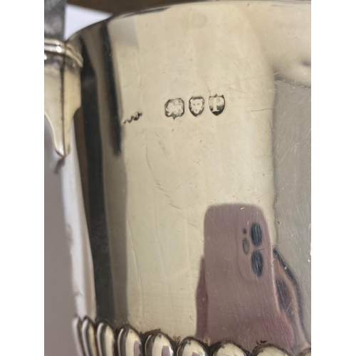 6 - A Victorian silver coffee pot, makers mark rubbed, London 1890, of pedestal half reeded form with eb... 