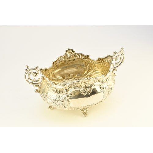 9 - A Victorian silver two handled dish, Albert Henry Thompson, Sheffield 1899, of oval form with emboss... 