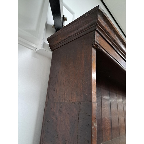 170 - A George III oak cross-banded dresser and rack The ogee cornice above four shelves, the lower flanke... 
