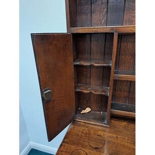 170 - A George III oak cross-banded dresser and rack The ogee cornice above four shelves, the lower flanke... 