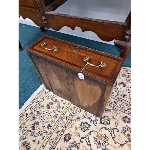 170 - A George III oak cross-banded dresser and rack The ogee cornice above four shelves, the lower flanke... 