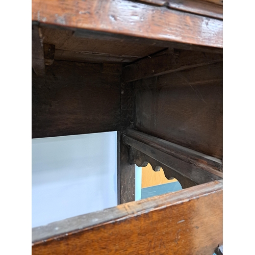 170 - A George III oak cross-banded dresser and rack The ogee cornice above four shelves, the lower flanke... 