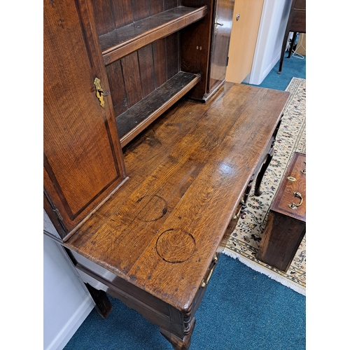 170 - A George III oak cross-banded dresser and rack The ogee cornice above four shelves, the lower flanke... 