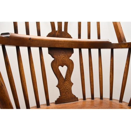 175 - A set of six reproduction ash Windsor armchairs With shaped and pierced splats, the seats raised on ... 