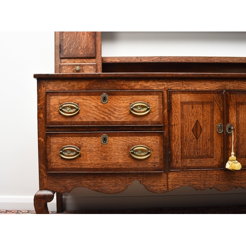 177 - A George III cross-banded oak dresser and rack, Shropshire The open rack with dentil cornice and scr... 