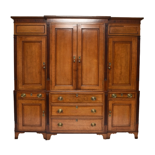 178 - A George III cross-banded oak break-front housekeeper's cupboard The reeded cornice above a mahogany... 