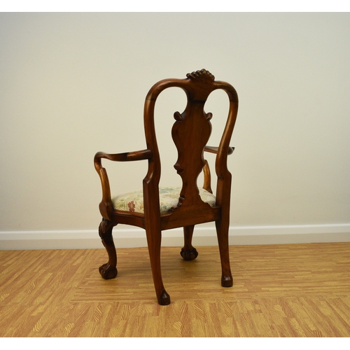 179 - A George I style walnut child's armchair With shaped splat and shell cresting, the shaped arms above... 