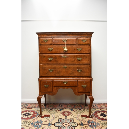 181 - A George II cross-banded and feather-banded walnut chest on stand The cavetto cornice above three sh... 