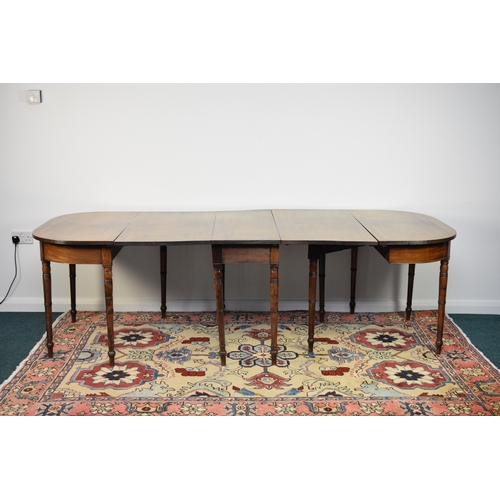 184 - A George III mahogany D-end extending dining table The top with reeded edge above a plain frieze, ra... 