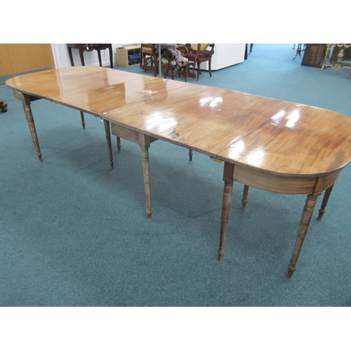 184 - A George III mahogany D-end extending dining table The top with reeded edge above a plain frieze, ra... 