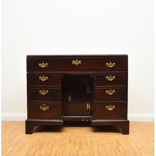 186 - A George III mahogany veneered campaign type kneehole desk The moulded top above a long frieze drawe... 