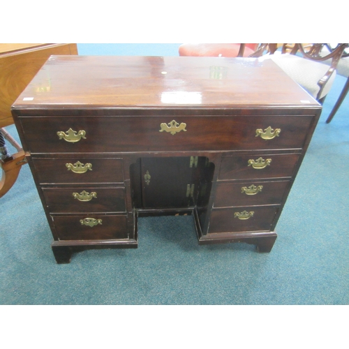 186 - A George III mahogany veneered campaign type kneehole desk The moulded top above a long frieze drawe... 