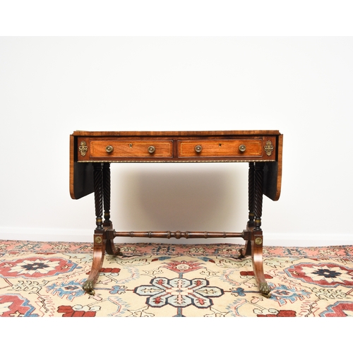 187 - A Regency brass inlaid rosewood sofa table The hinged rectangular top with rounded corners, fitted w... 