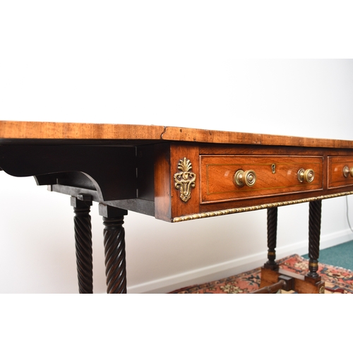 187 - A Regency brass inlaid rosewood sofa table The hinged rectangular top with rounded corners, fitted w... 