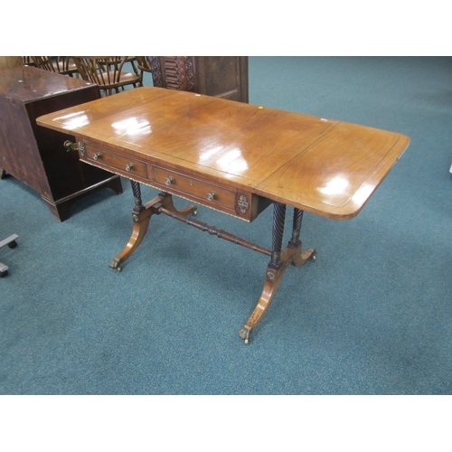 187 - A Regency brass inlaid rosewood sofa table The hinged rectangular top with rounded corners, fitted w... 