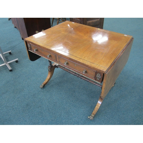 187 - A Regency brass inlaid rosewood sofa table The hinged rectangular top with rounded corners, fitted w... 