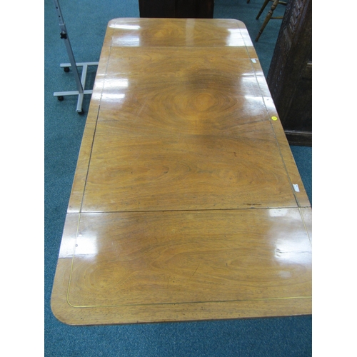 187 - A Regency brass inlaid rosewood sofa table The hinged rectangular top with rounded corners, fitted w... 