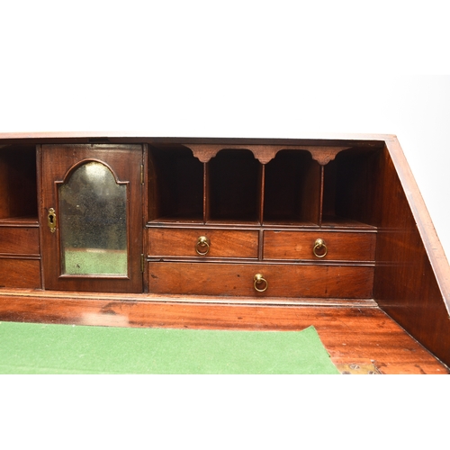 188 - A George III mahogany bureau The cross-banded fall front enclosing a fitted interior with six drawer... 