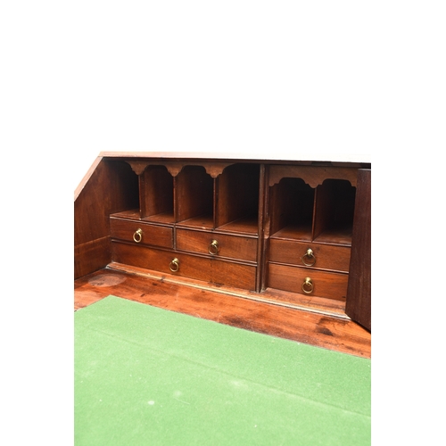 188 - A George III mahogany bureau The cross-banded fall front enclosing a fitted interior with six drawer... 