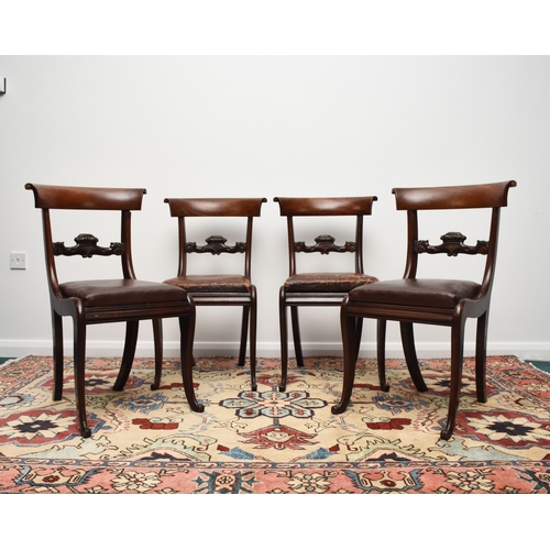 191 - A set of four William IV rosewood dining chairs The curved top rails with scroll ends above scroll a... 