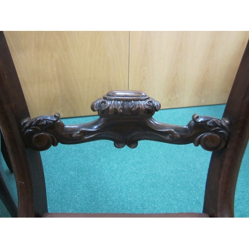 191 - A set of four William IV rosewood dining chairs The curved top rails with scroll ends above scroll a... 