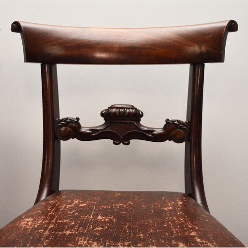 191 - A set of four William IV rosewood dining chairs The curved top rails with scroll ends above scroll a... 