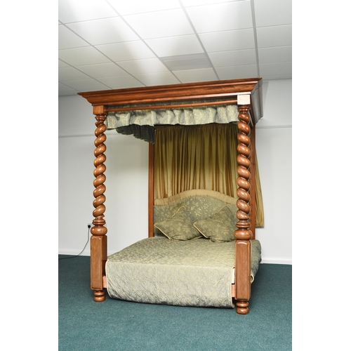 195 - A mahogany four-poster bed in the George III style The canopy with ogee cornice and pleated yellow s... 