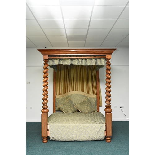195 - A mahogany four-poster bed in the George III style The canopy with ogee cornice and pleated yellow s... 