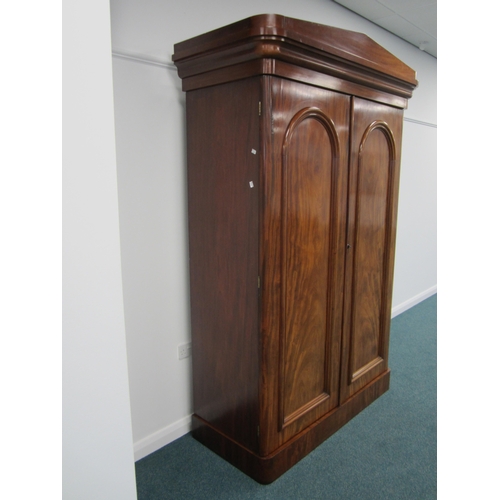 196 - A Victorian mahogany armoire The pedimented ogee cornice above twin arch-panelled doors, the interio... 