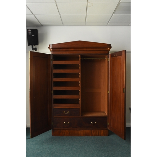 196 - A Victorian mahogany armoire The pedimented ogee cornice above twin arch-panelled doors, the interio... 
