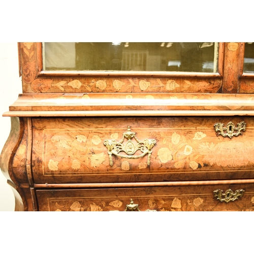 199 - A Dutch walnut, fruitwood and marquetry bombe display cabinet, 19th century The arched top centred b... 