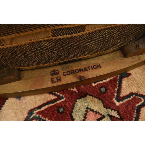 200 - A 1953 Queen Elizabeth II coronation, limed oak stool, the concave shaped seat covered in a blue vel... 