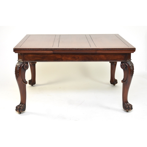 202 - A mahogany draw-leaf dining table, early 20th century The top with guilloche moulded edge above a pl... 