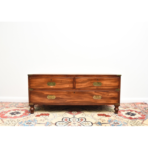 204 - A reproduction campaign type coffee table chest The brass-mounted top inset with a tooled green leat... 